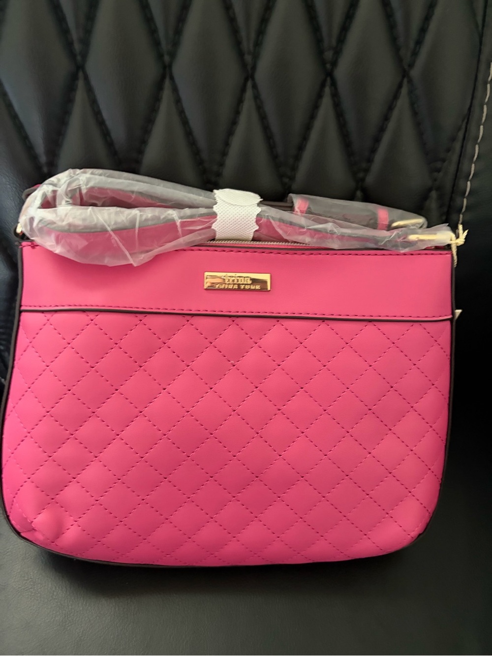 Trina Turk pink quilted crossbody bag...